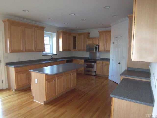 7904 Ridge Pointe Lane Raleigh, NC 27615 - Photo 3 of 11 a kitchen with stainless steel appliances granite countertop a sink and a stove