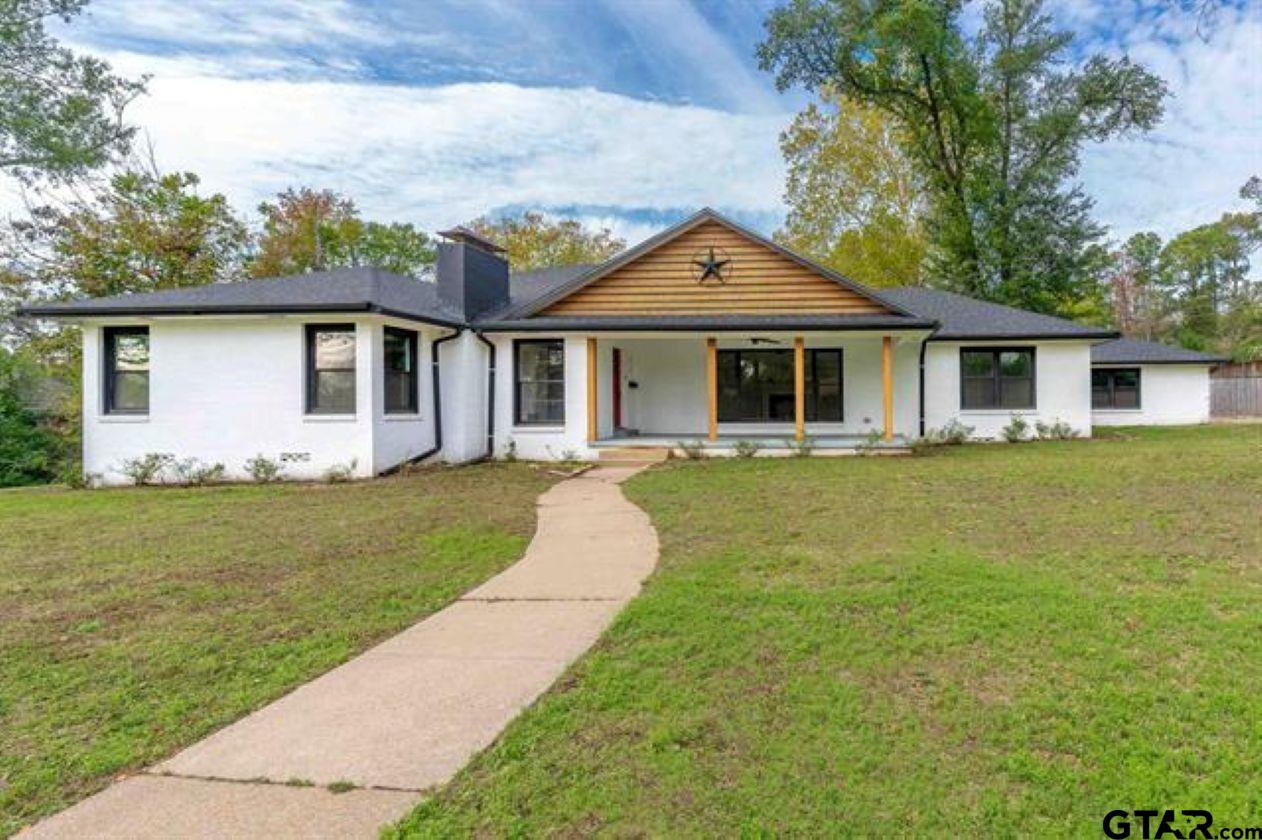 a front view of house with yard and green space