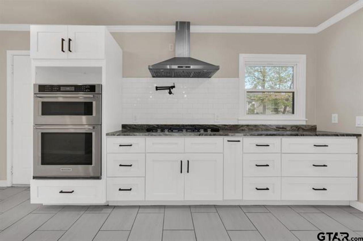 2425 Oak Lane Tyler, TX 75701 - Photo 12 of 33 a kitchen with white cabinets stainless steel appliances and a window