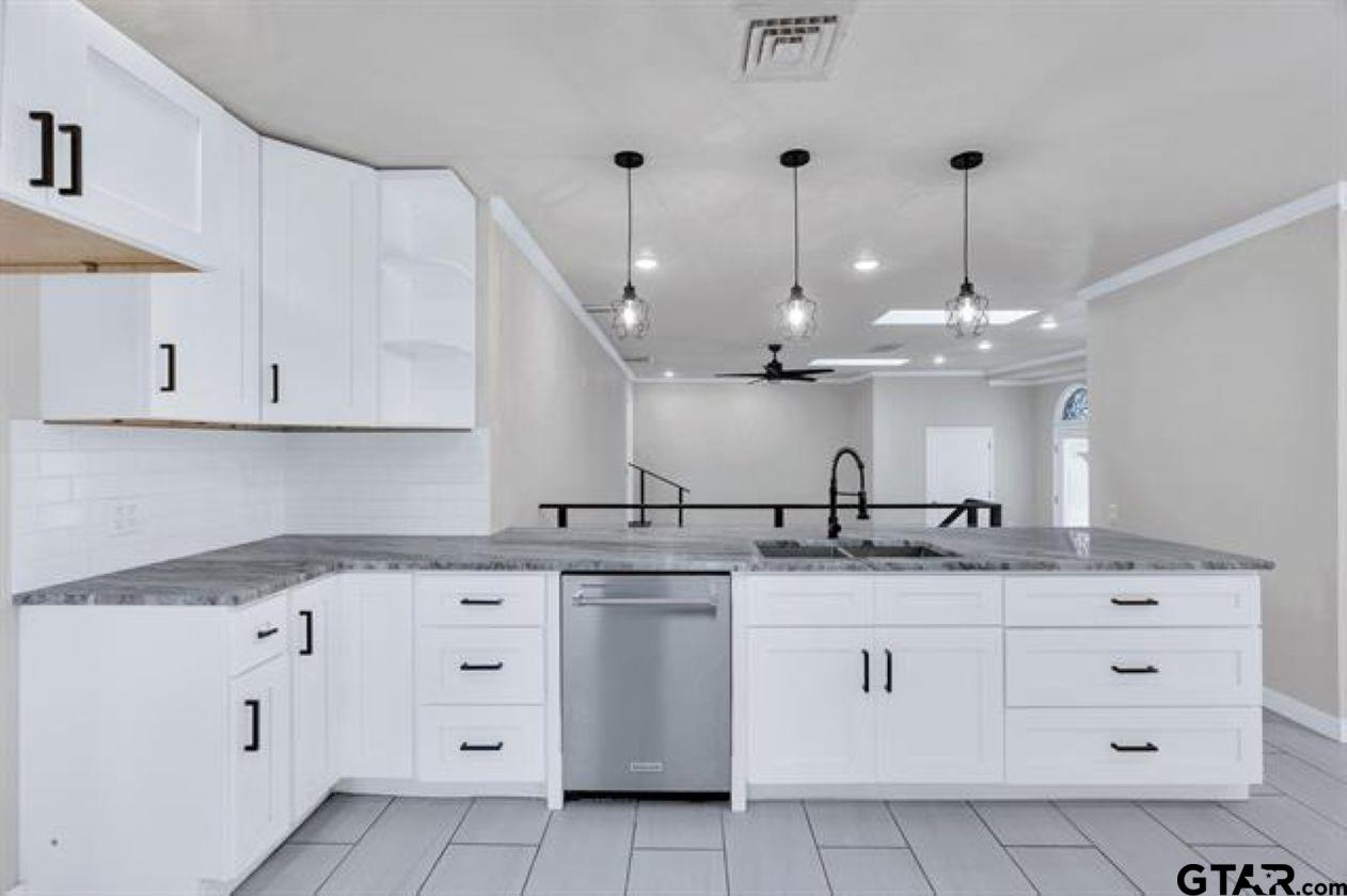 2425 Oak Lane Tyler, TX 75701 - Photo 13 of 33 a kitchen with granite countertop a white sink and cabinets