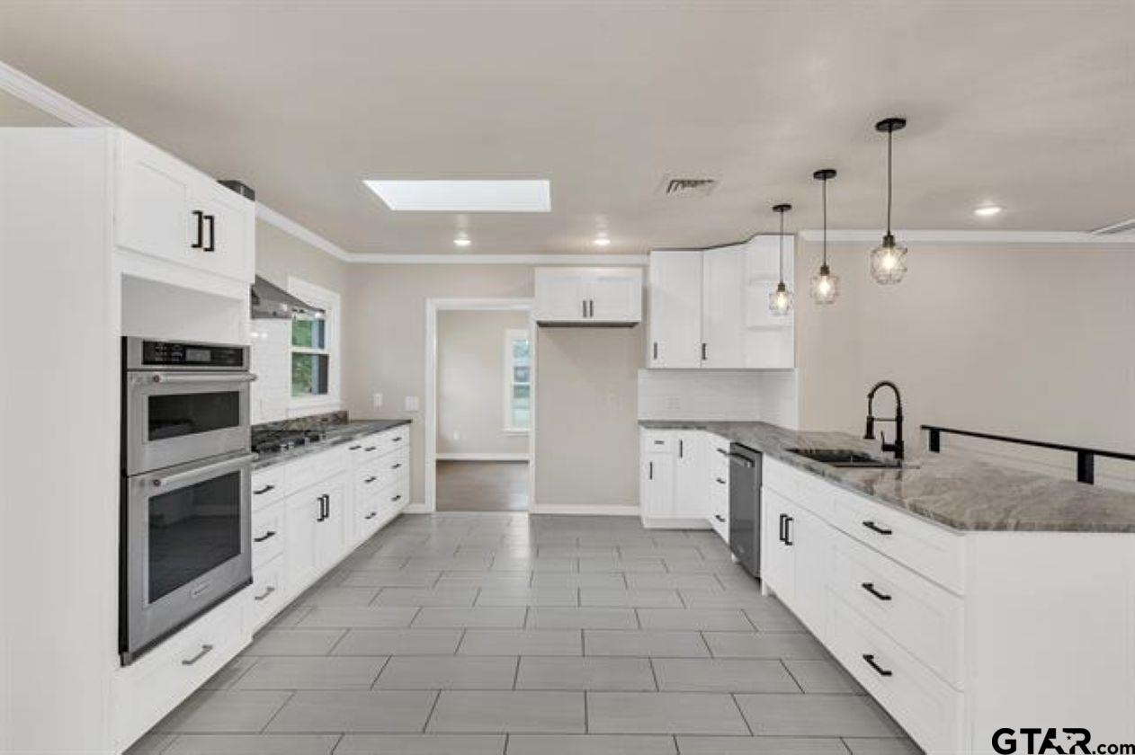 2425 Oak Lane Tyler, TX 75701 - Photo 14 of 33 a large kitchen with stainless steel appliances granite countertop a sink and cabinets