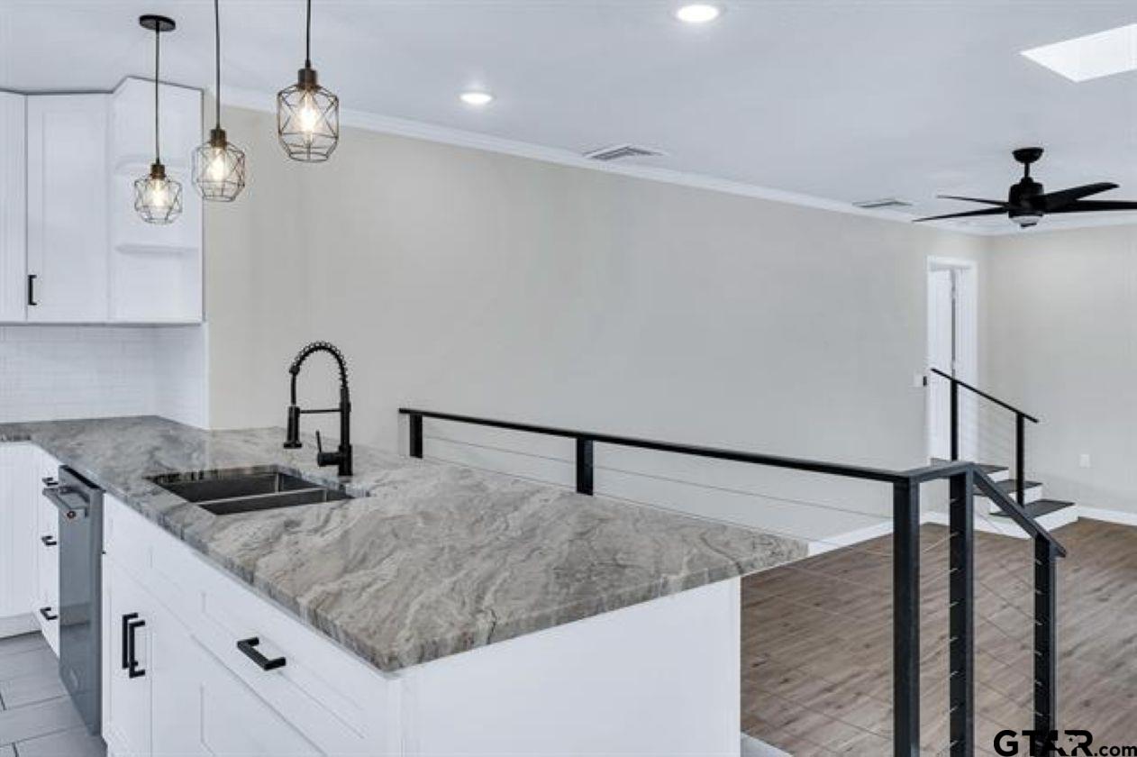 2425 Oak Lane Tyler, TX 75701 - Photo 15 of 33 a kitchen with granite countertop a sink stainless steel appliances and cabinets