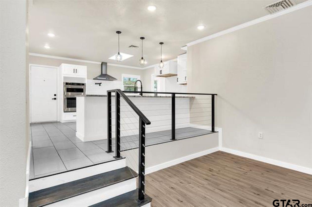 2425 Oak Lane Tyler, TX 75701 - Photo 16 of 33 a view of entryway and kitchen with wooden floor