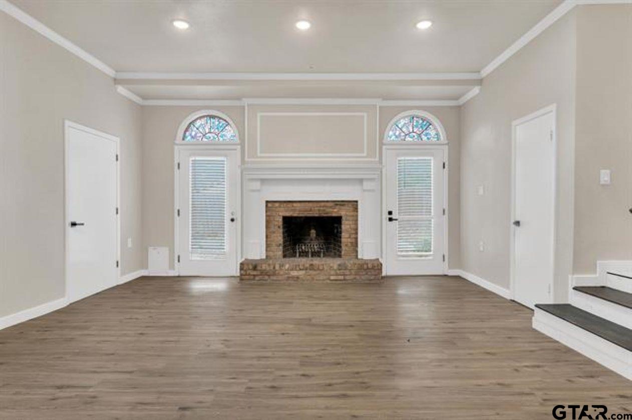 2425 Oak Lane Tyler, TX 75701 - Photo 17 of 33 a view of empty room with wooden floor and fireplace