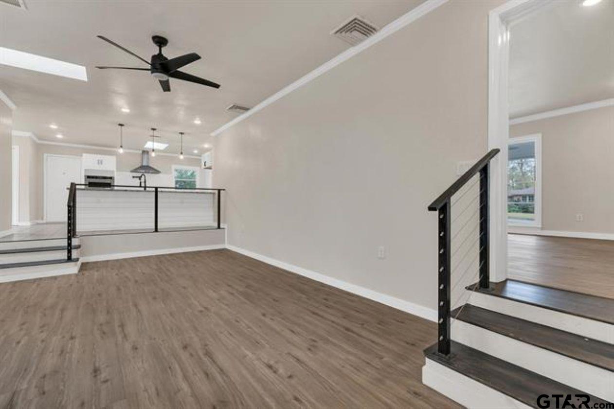 2425 Oak Lane Tyler, TX 75701 - Photo 20 of 33 a view of a livingroom with wooden floor and a ceiling fan