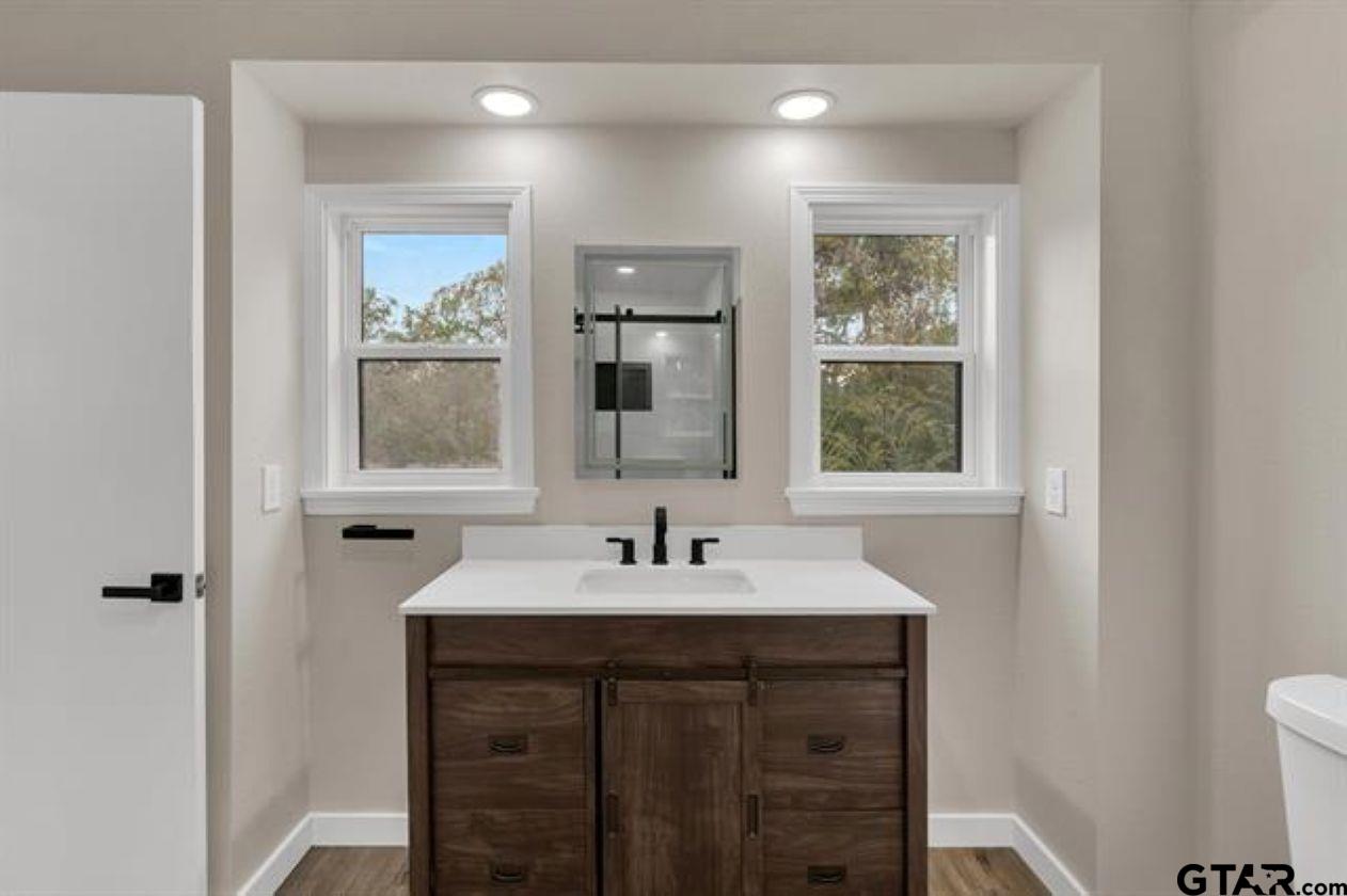 2425 Oak Lane Tyler, TX 75701 - Photo 22 of 33 a bathroom with a sink vanity and a mirror
