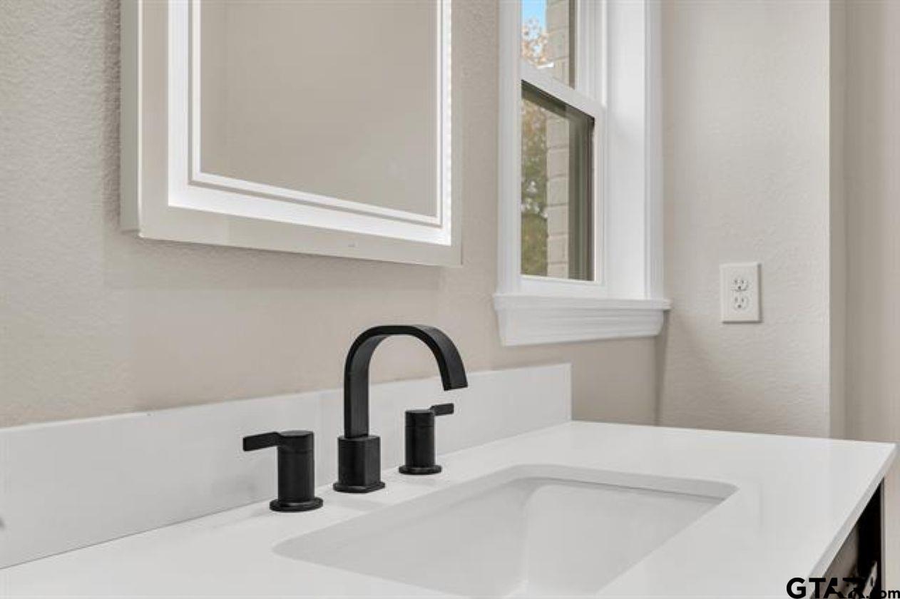 2425 Oak Lane Tyler, TX 75701 - Photo 23 of 33 a bathroom with a sink and mirror