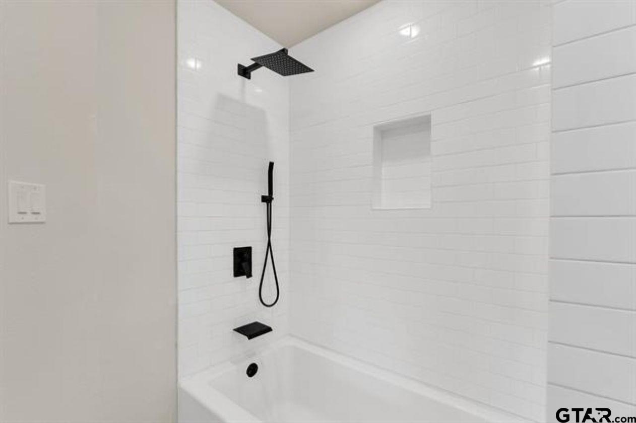 2425 Oak Lane Tyler, TX 75701 - Photo 28 of 33 a bathroom with a shower and a bathtub