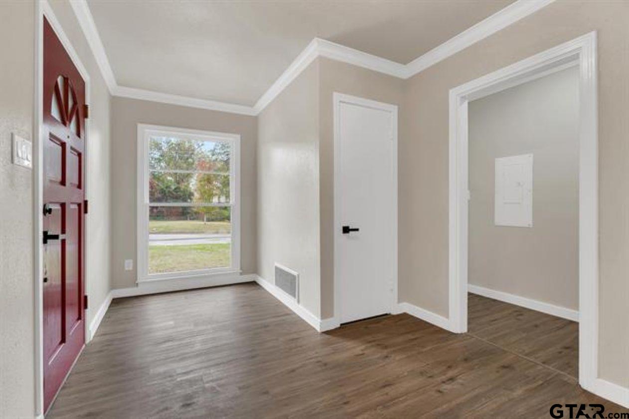 2425 Oak Lane Tyler, TX 75701 - Photo 4 of 33 a view of an empty room with a window and wooden floor