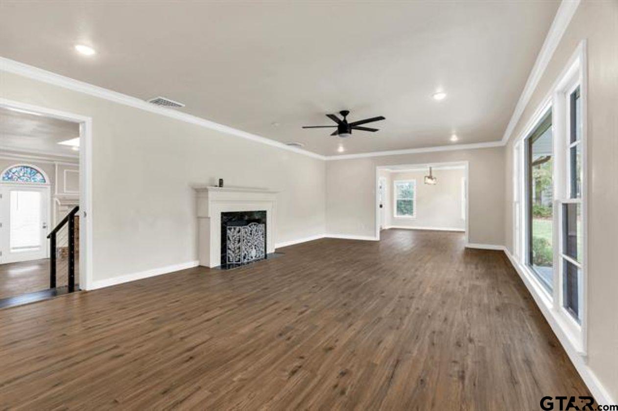 2425 Oak Lane Tyler, TX 75701 - Photo 5 of 33 a view of empty room with wooden floor and fireplace
