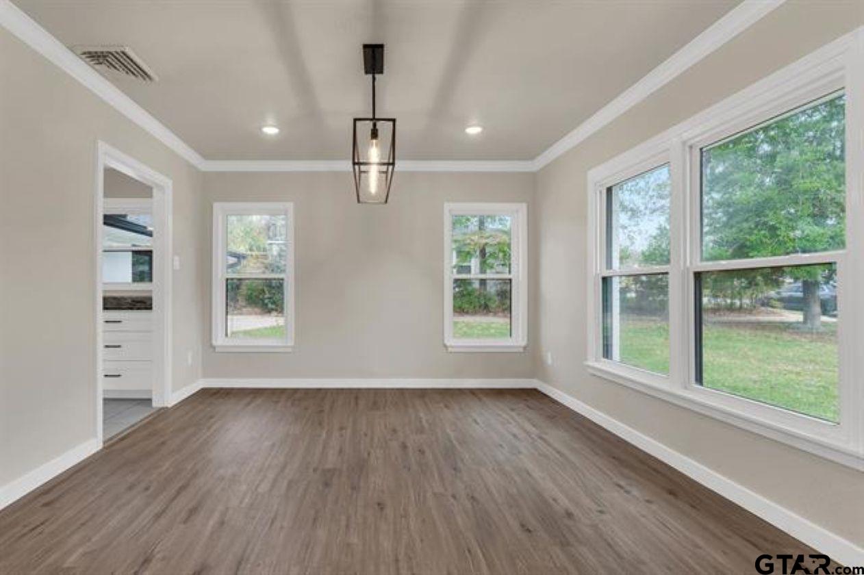 2425 Oak Lane Tyler, TX 75701 - Photo 8 of 33 a view of an empty room with a window and wooden floor
