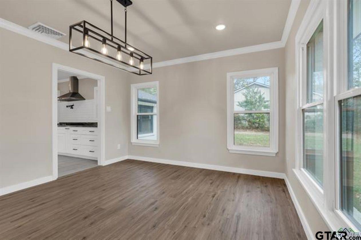 2425 Oak Lane Tyler, TX 75701 - Photo 9 of 33 a view of empty room with wooden floor and windows