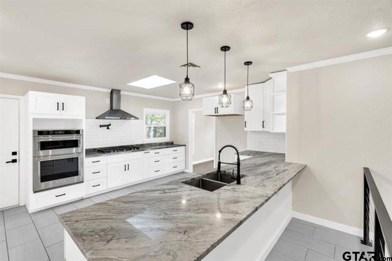 2425 Oak Lane Tyler, TX 75701 - Photo 10 of 33 a kitchen with stainless steel appliances granite countertop a sink a oven and a stove
