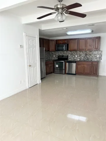 a large kitchen with a lot of wooden cabinets