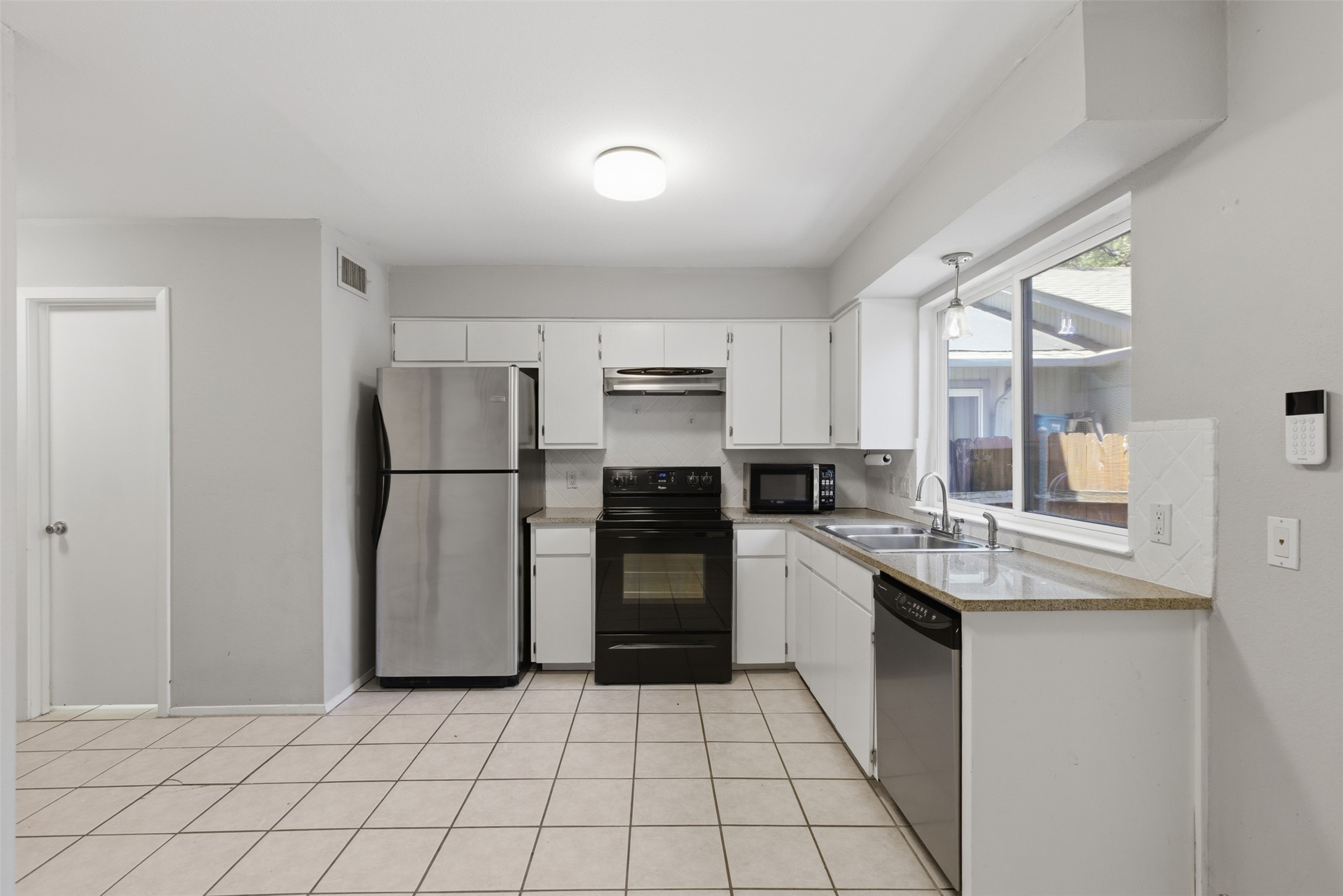 4204 Hudson Bend Road, Unit B Austin, TX 78734 - Photo 14 of 37 Kitchen featuring white cabinetry, light countertops, and tile flooring