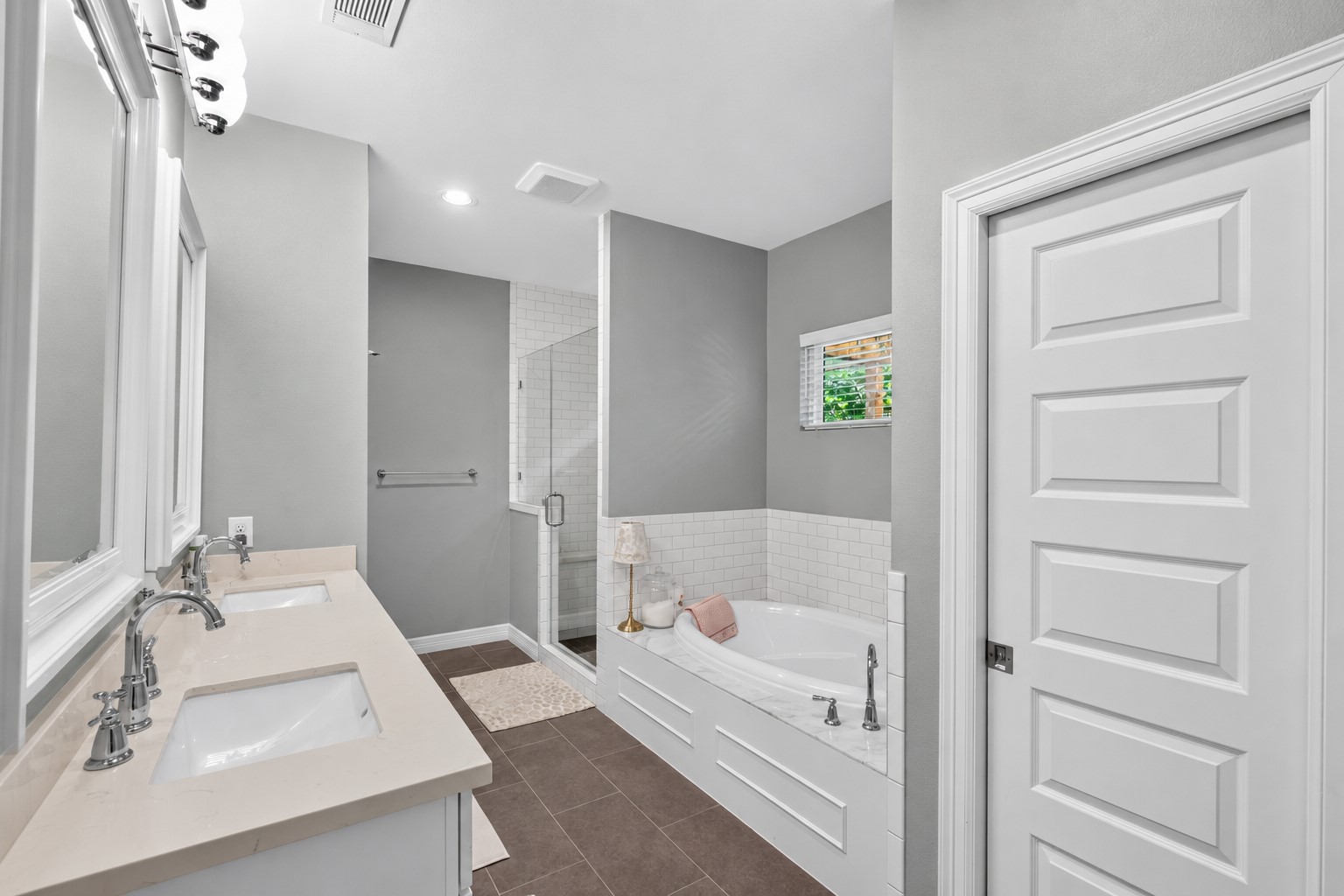 1722 Chippendale Road Houston, TX 77018 - Photo 20 of 41 Elegant primary bathroom featuring a dual-sink vanity, spacious glass-enclosed shower, and a luxurious soaking tub, all accented by contemporary fixtures and a neutral color palette.