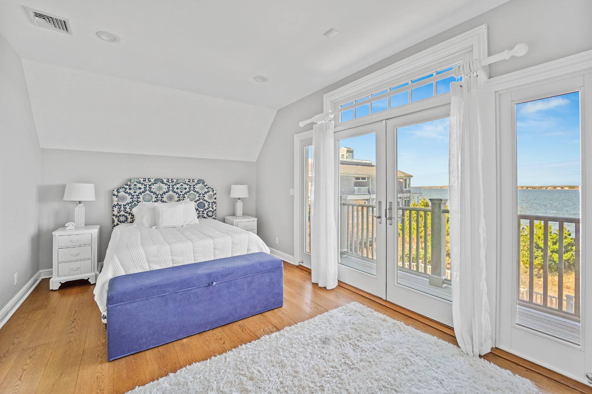 Undisclosed Address Westhampton, NY 11978 - Photo 21 of 22 a bedroom with a bed and glass door