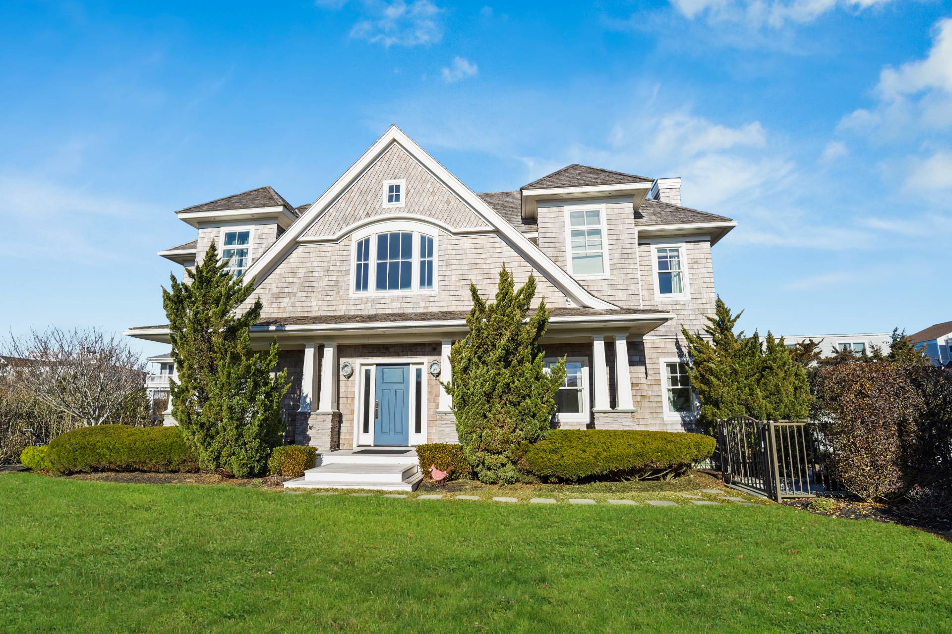 Undisclosed Address Westhampton, NY 11978 - Photo 5 of 22 a front view of a house with a garden and plants