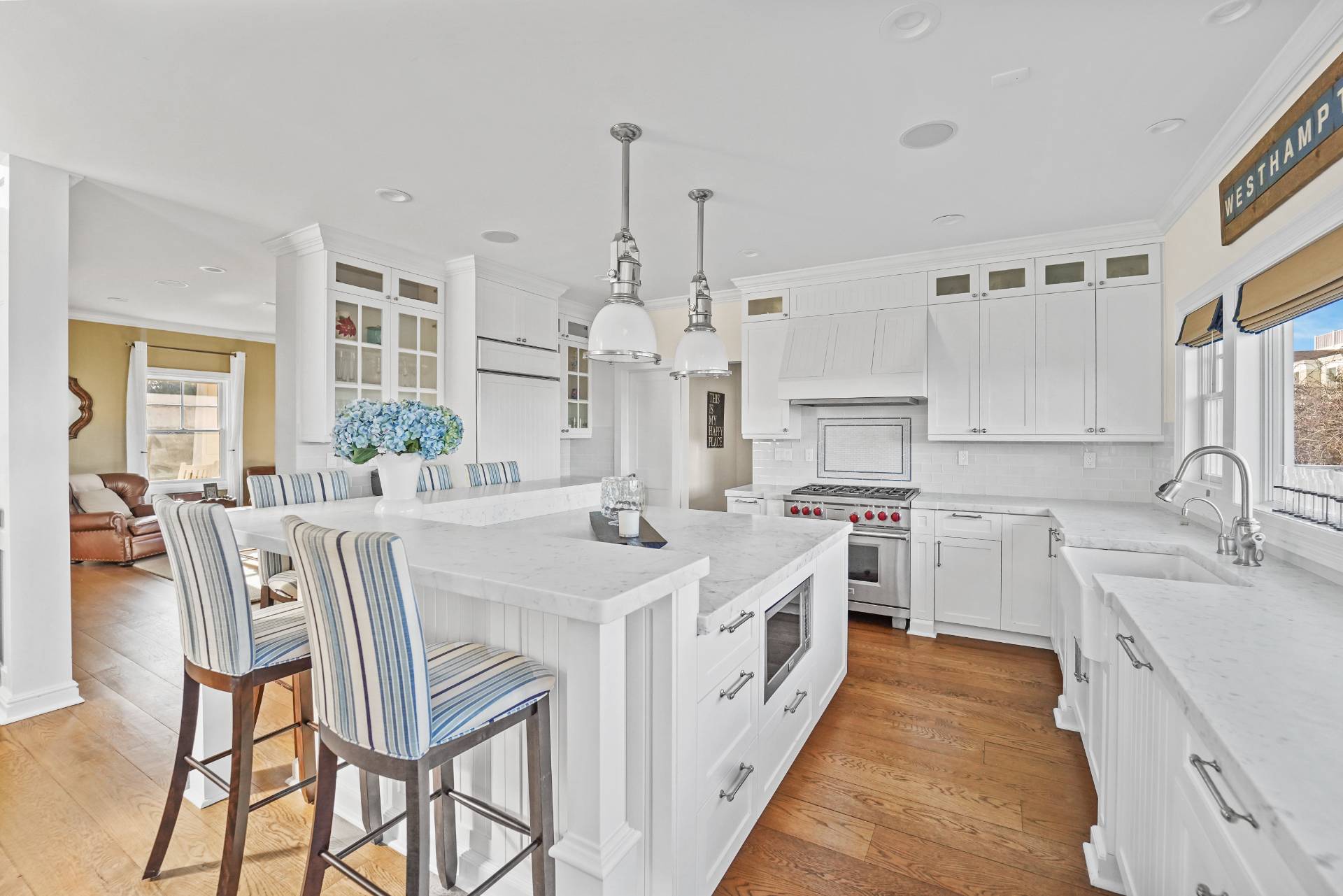 Undisclosed Address Westhampton, NY 11978 - Photo 8 of 22 a large kitchen with kitchen island a stove a sink a dining table and chairs