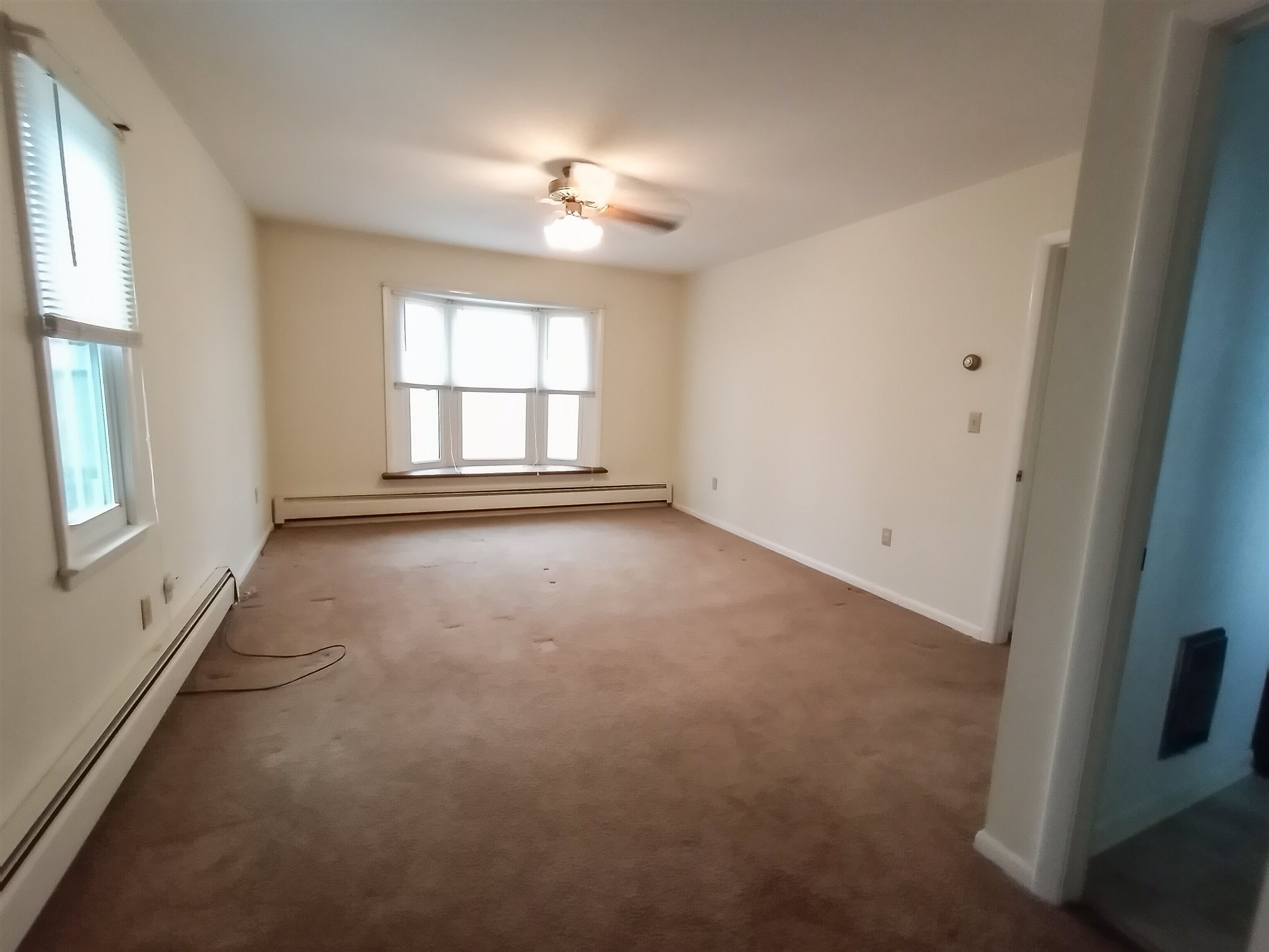 619 Miller Farm Road Staunton, VA 24401 - Photo 19 of 40 an empty room with windows and chandelier