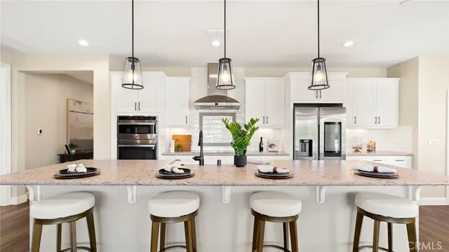 a large kitchen with kitchen island lots of counter space and wooden floor