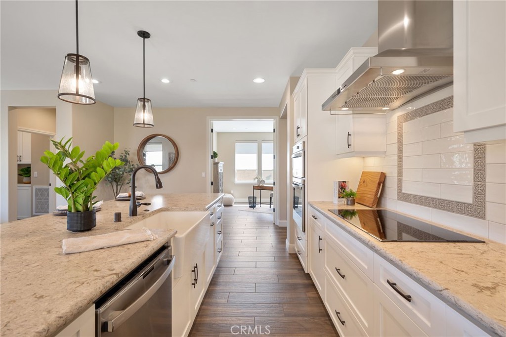867 Trail View Place Nipomo, CA 93444 - Photo 16 of 71 a large kitchen with stainless steel appliances kitchen island granite countertop a sink and a wooden floor