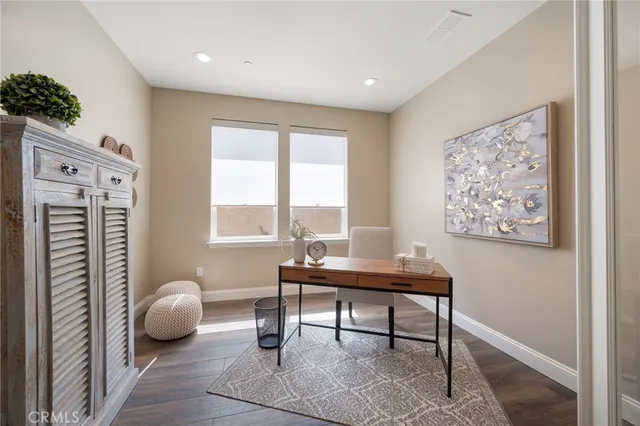 a bedroom with a bed and large windows