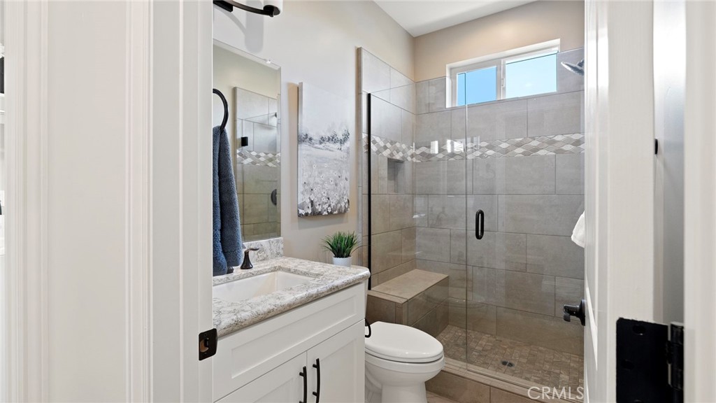 867 Trail View Place Nipomo, CA 93444 - Photo 41 of 71 a bathroom with a granite countertop shower a toilet and a sink