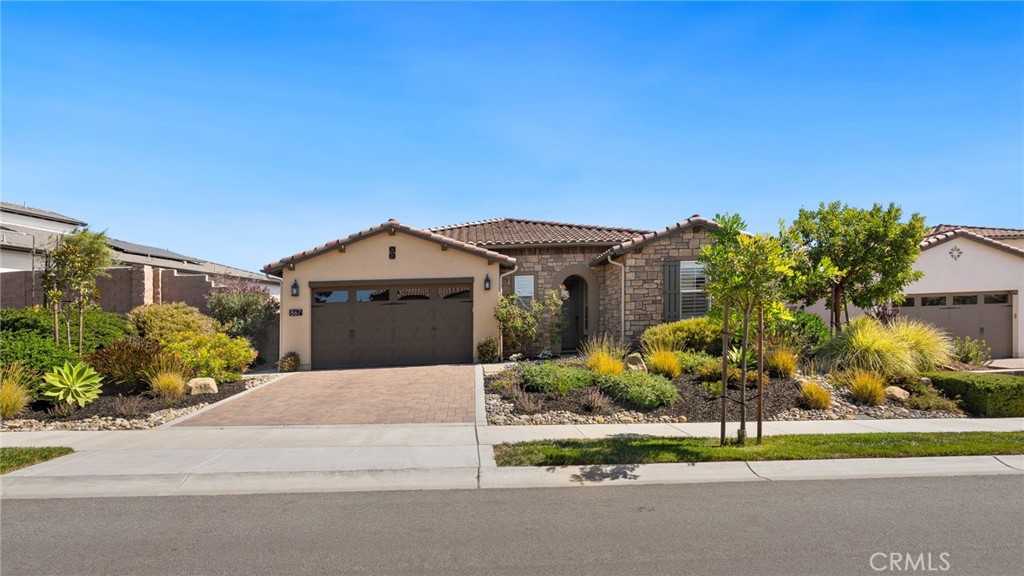 867 Trail View Place Nipomo, CA 93444 - Photo 57 of 71 a front view of a house with a garden and trees