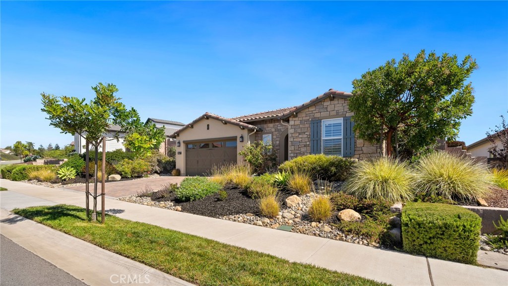 867 Trail View Place Nipomo, CA 93444 - Photo 58 of 71 a front view of a house with a yard and potted plants