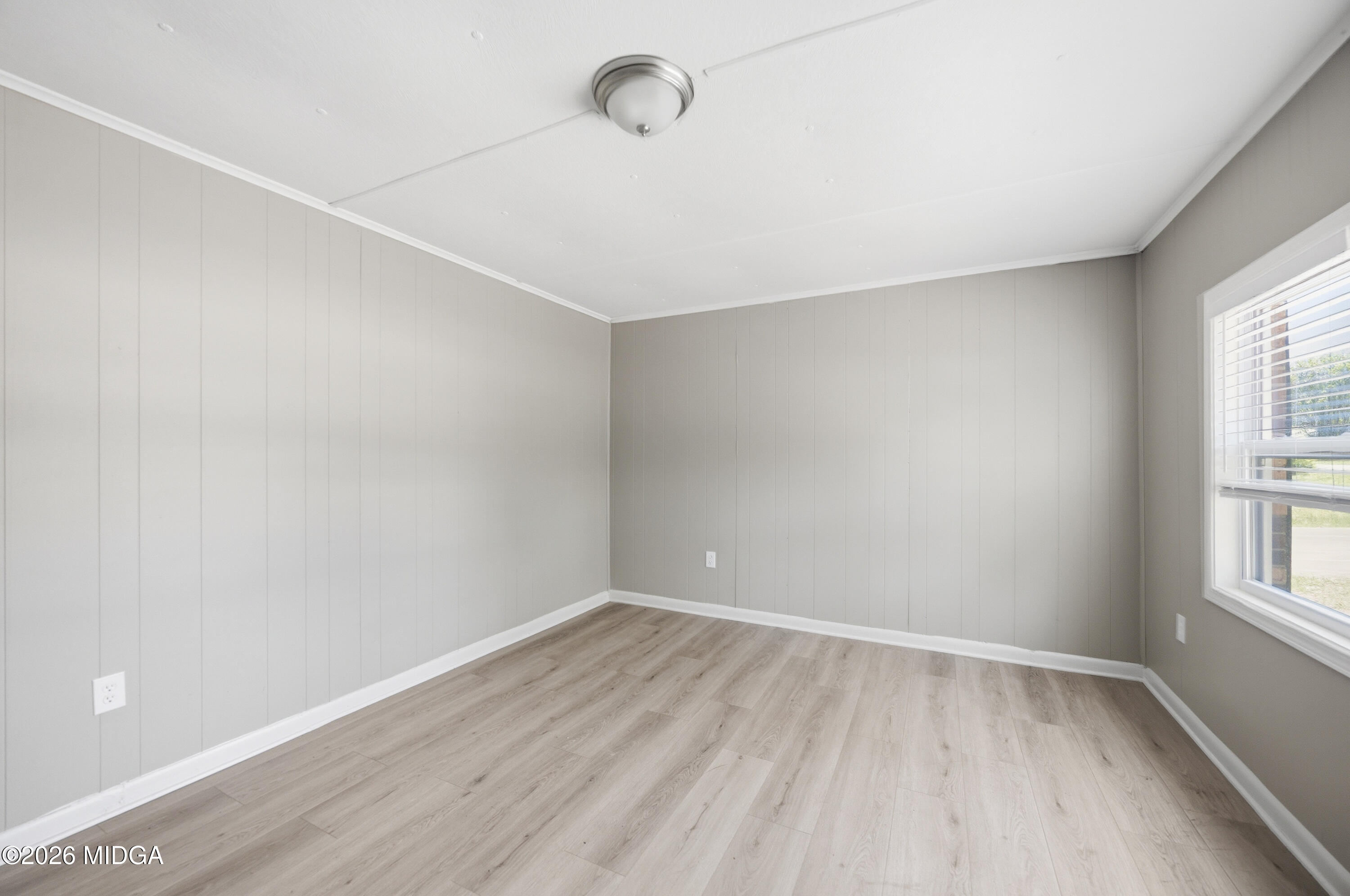 427 Gun Club Road Fort Valley, GA 31030 - Photo 4 of 26 wooden floor in an empty room with a window