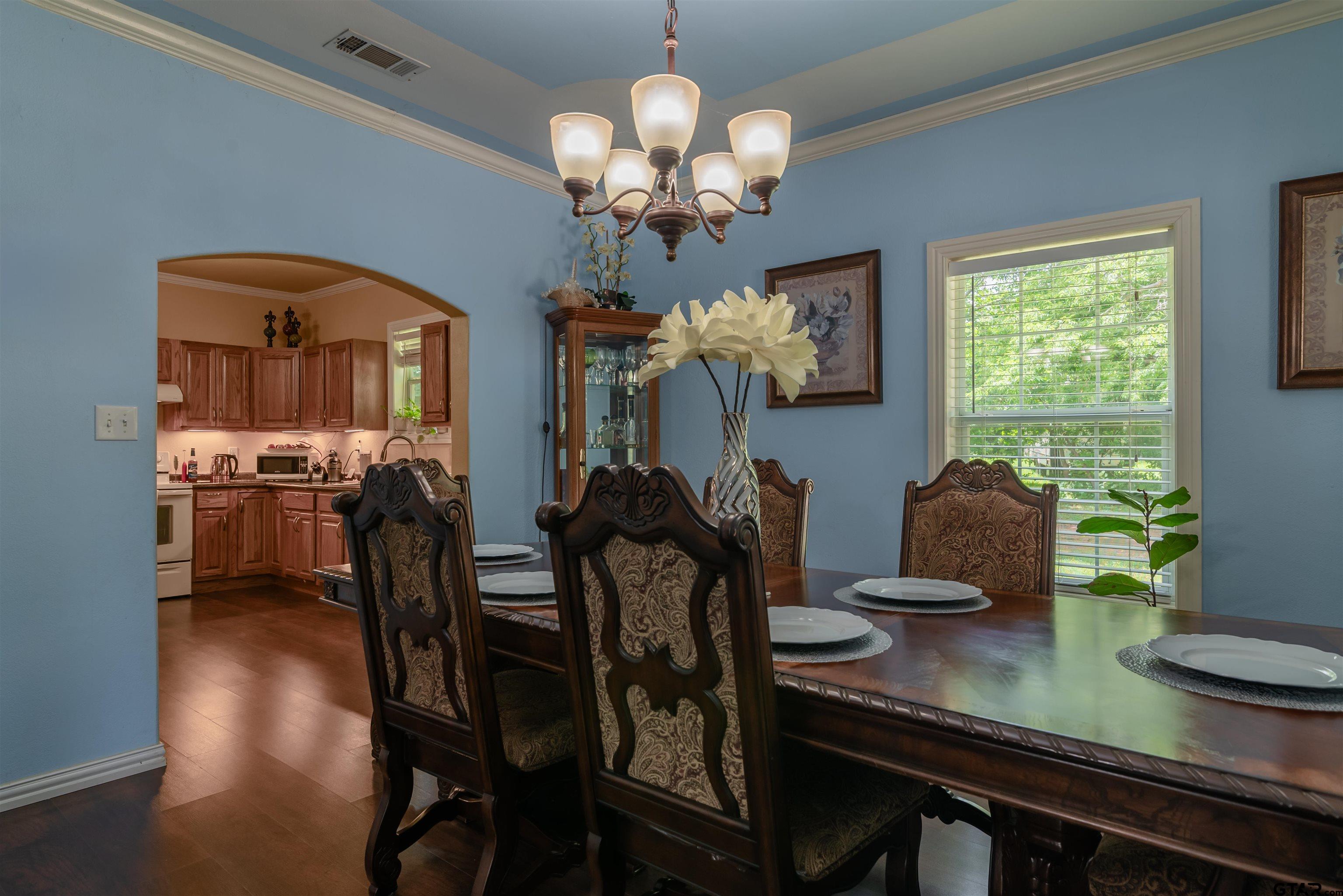 427 East Locust Street Tyler, TX 75702 - Photo 10 of 42 a view of a dining room with furniture and chandelier