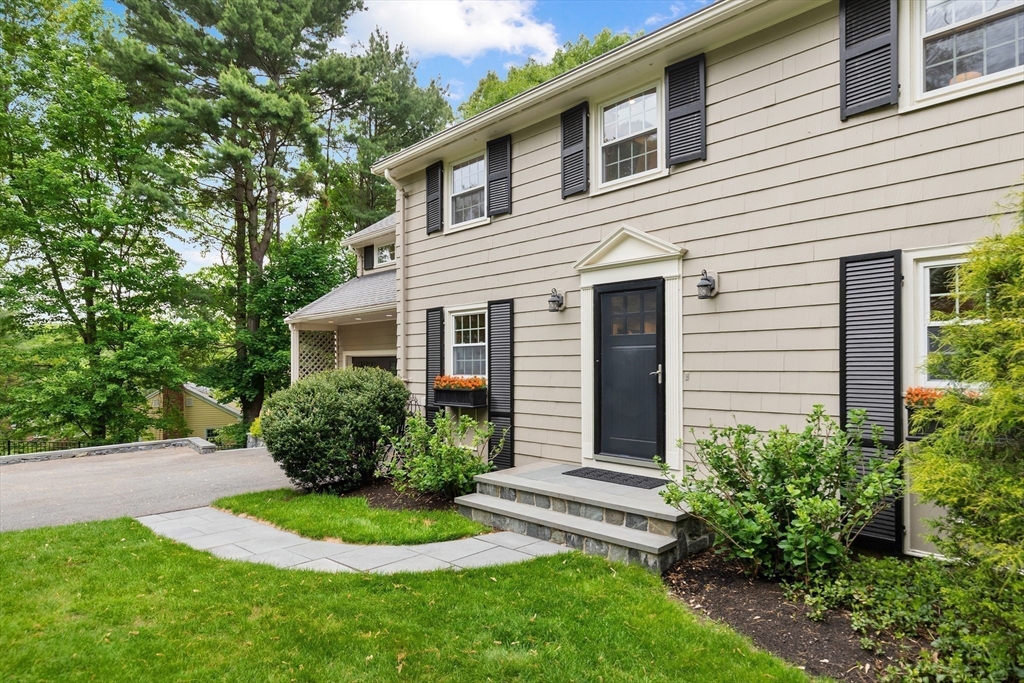 105 Thornberry Road Winchester, MA 01890 - Photo 28 of 35 a front view of a house with a garden