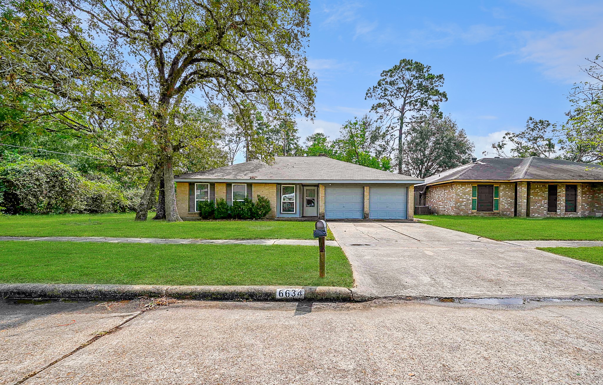 6634 Bridgegate Drive Spring, TX 77373 - Photo 3 of 16 a front view of a house with a yard and trees