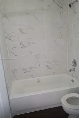 a bathroom with a bathtub and a toilet