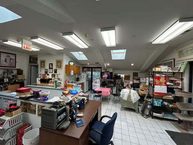 a kitchen with lots of furniture and clutter