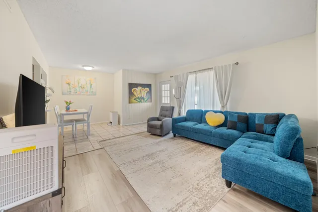 a view of staircase with lots of frames on wall and stairs