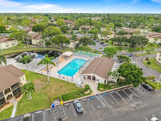 an aerial view of residential houses with outdoor space and parking