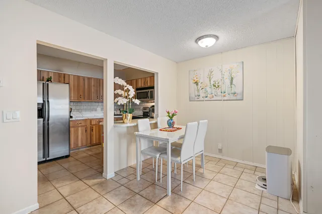 a kitchen with a refrigerator and cabinets