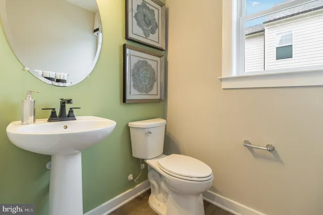 a bathroom with a sink mirror and toilet