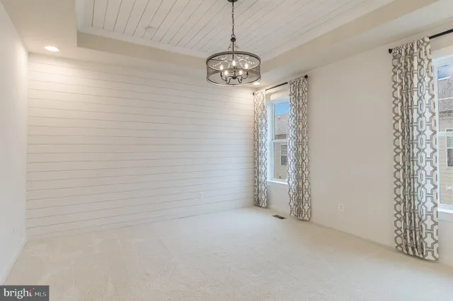 a view of an empty room with a chandelier