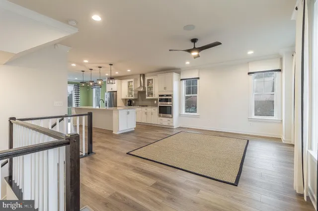 a view of a kitchen with furniture and wooden floor