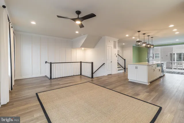 a view of a kitchen with a sink and a living room view
