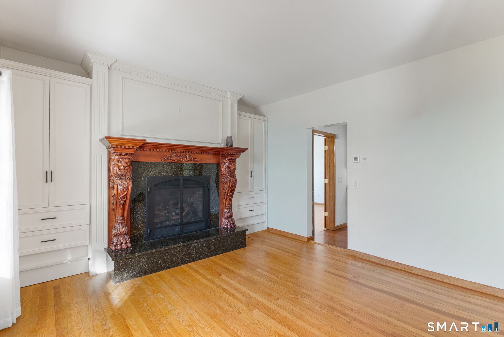 341 High Street Extension Thomaston, CT 06787 - Photo 13 of 39 a room with a fireplace and a wooden floor