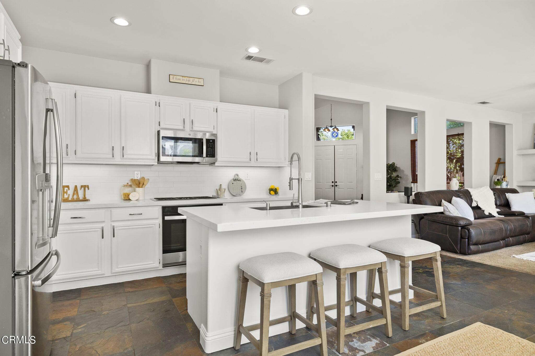 4654 Via Dulce Camarillo, CA 93012 - Photo 17 of 51 a kitchen with kitchen island granite countertop a sink and white cabinets