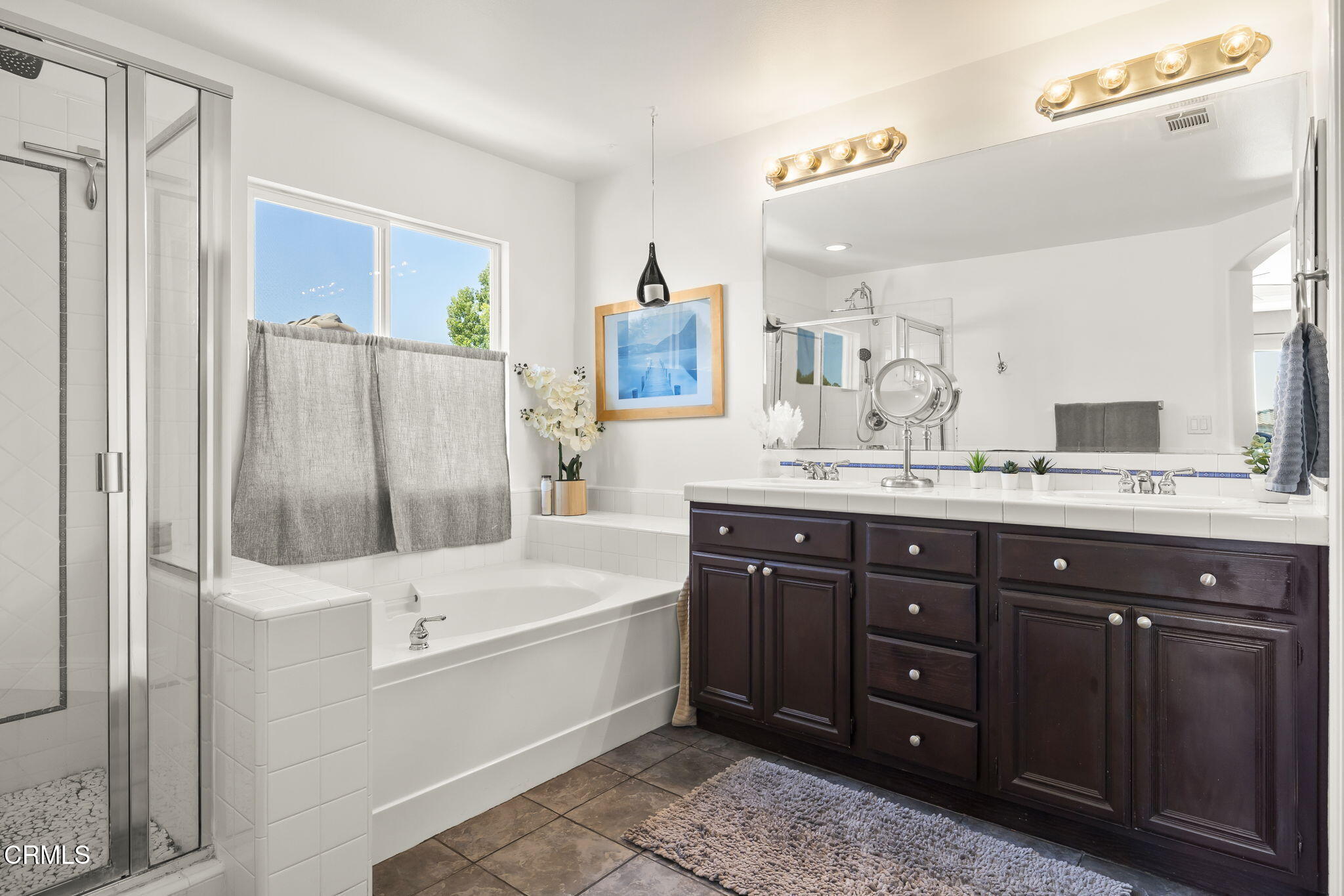 4654 Via Dulce Camarillo, CA 93012 - Photo 38 of 51 a bathroom with a tub sink and mirror