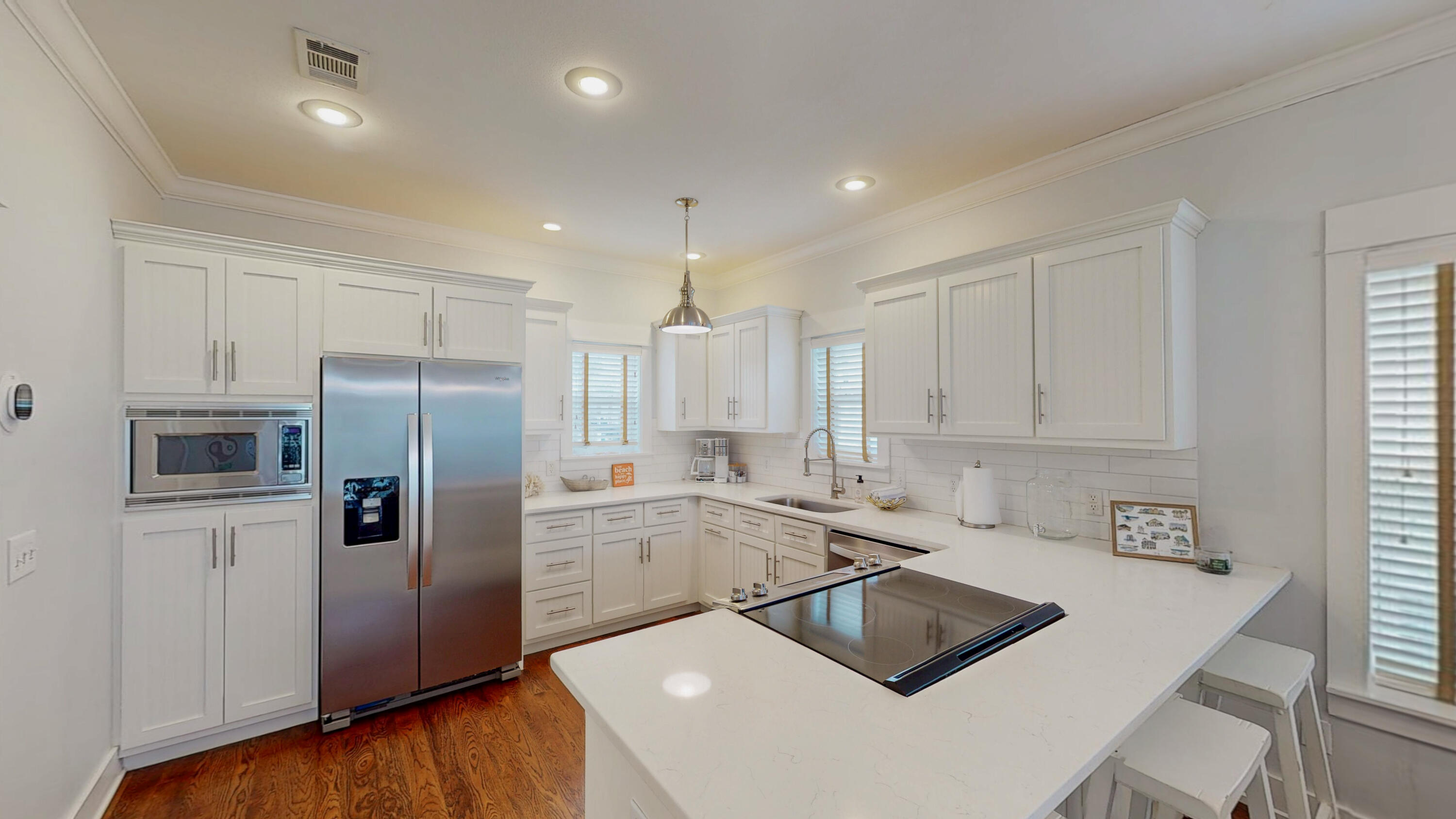 249 Beach Bike Way Inlet Beach, FL 32461 - Photo 13 of 38 a kitchen that has a refrigerator a sink and white cabinets with wooden floor