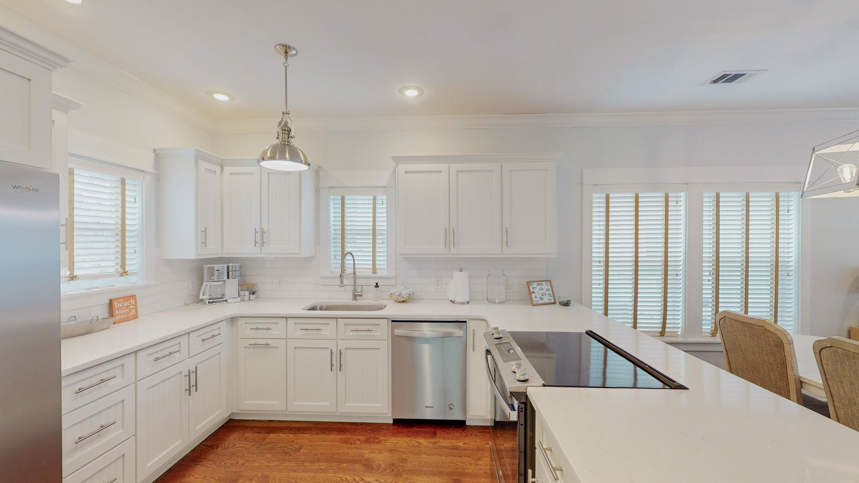 249 Beach Bike Way Inlet Beach, FL 32461 - Photo 14 of 38 a kitchen with a sink dishwasher a stove top oven a refrigerator with white cabinets and wooden floor