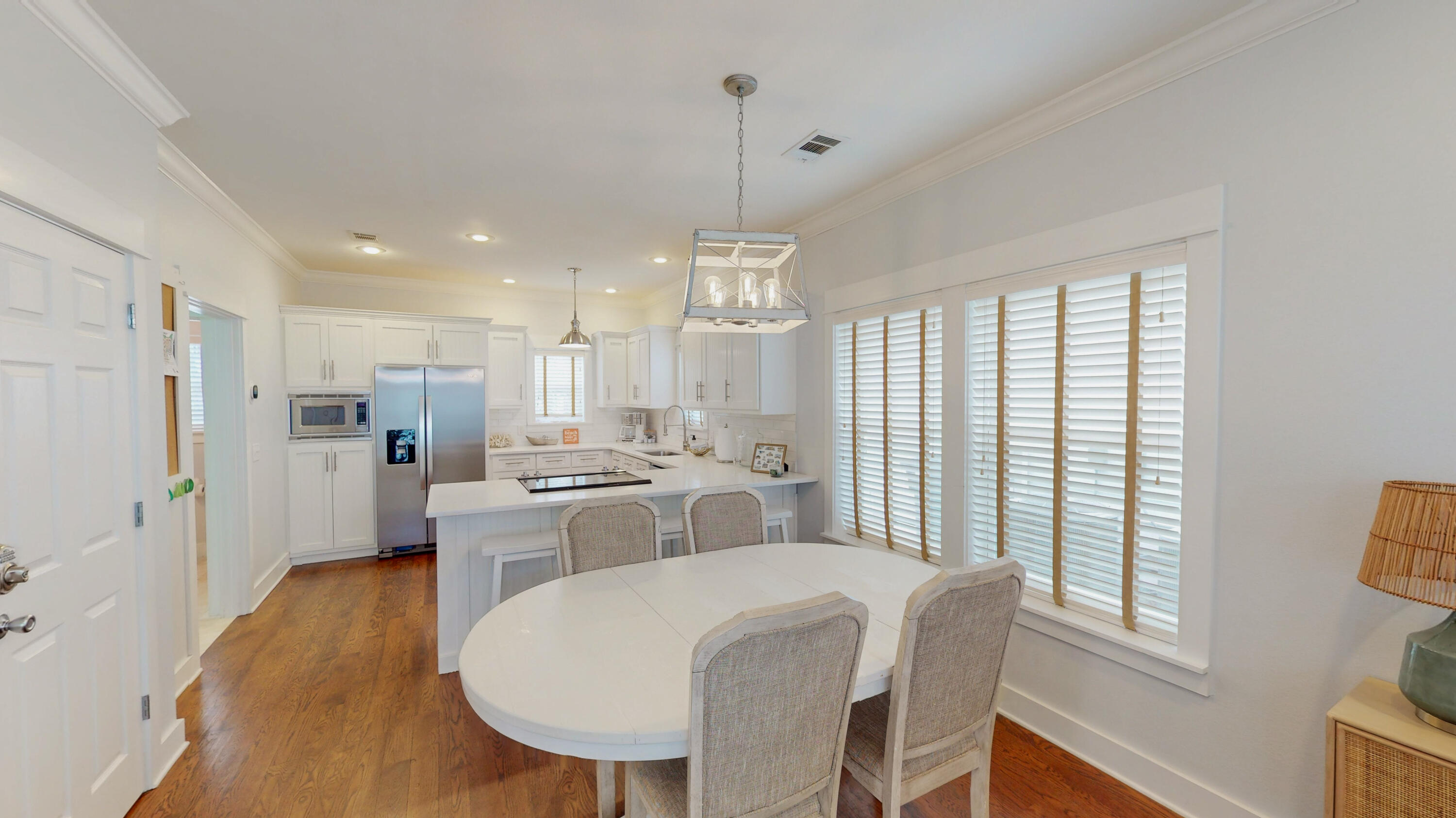 249 Beach Bike Way Inlet Beach, FL 32461 - Photo 10 of 38 a large kitchen with sink a refrigerator a stove a dining table and chairs