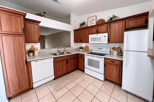 a kitchen with stainless steel appliances granite countertop a refrigerator sink and stove